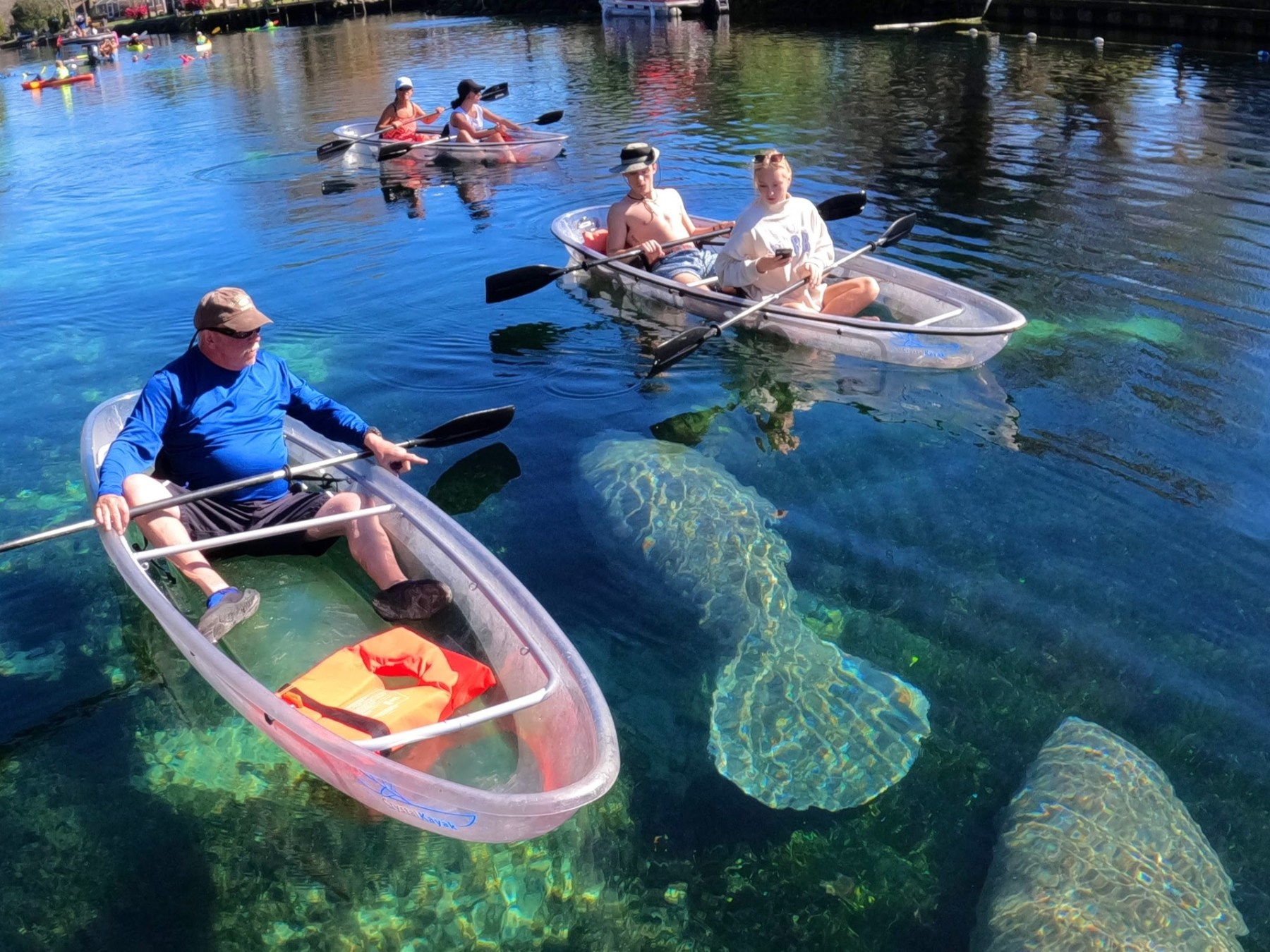 a group of people rowing a boat in the water