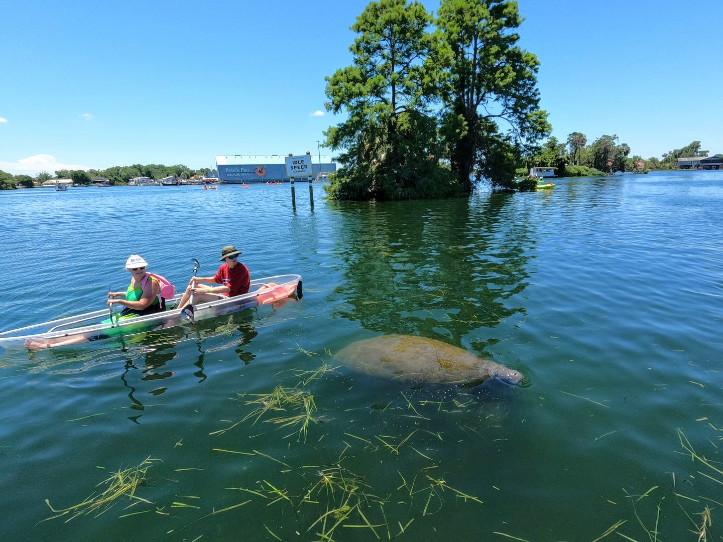 a group of people in a small boat in a body of water