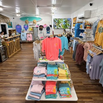 a person sitting at a table in front of a store